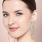 Peach-Coloured Gold-Plated Handcrafted AD Stones Peacock-Shaped Drop Earrings